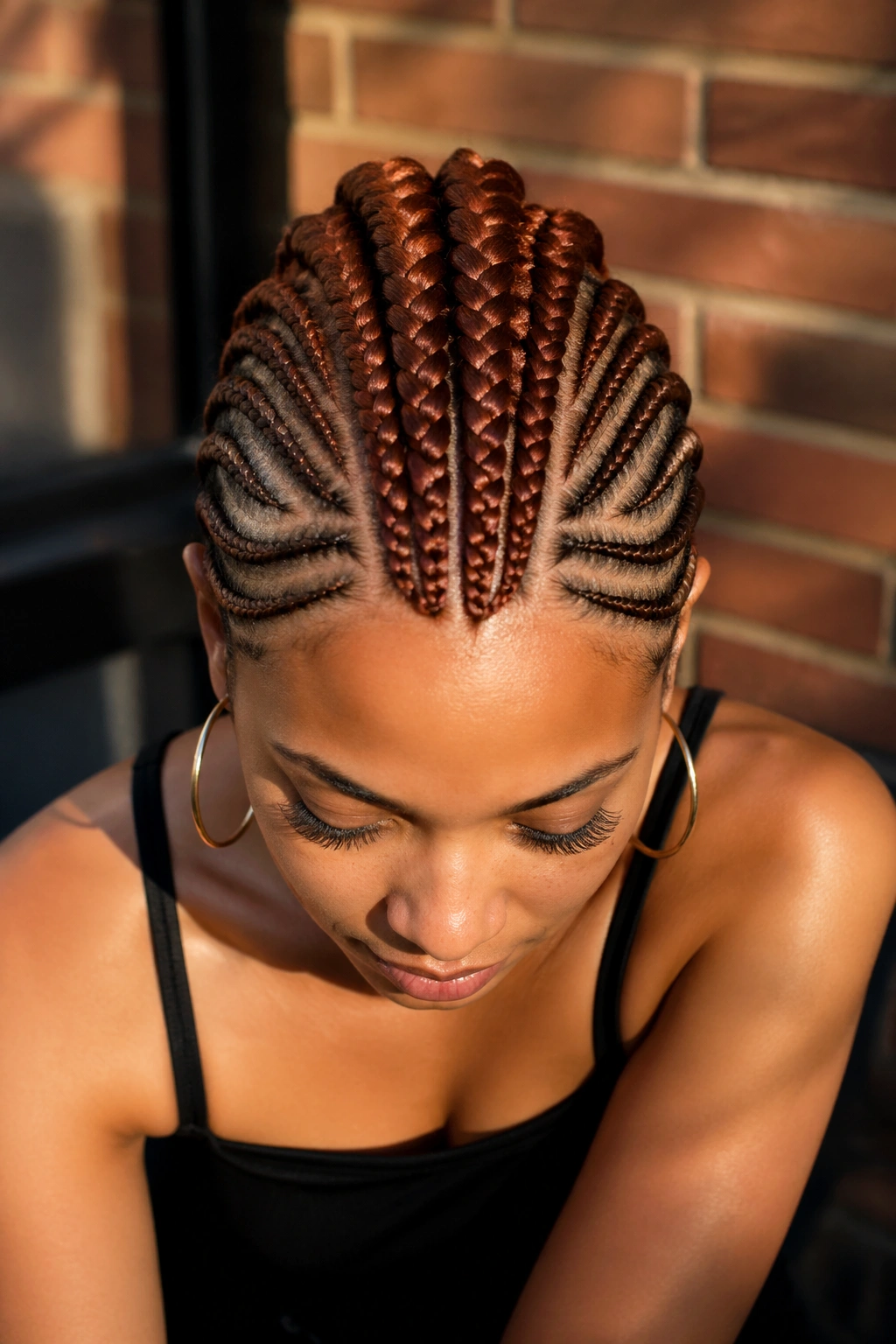 Medium close-up of a person with an auburn mohawk pattern and shaved sides
