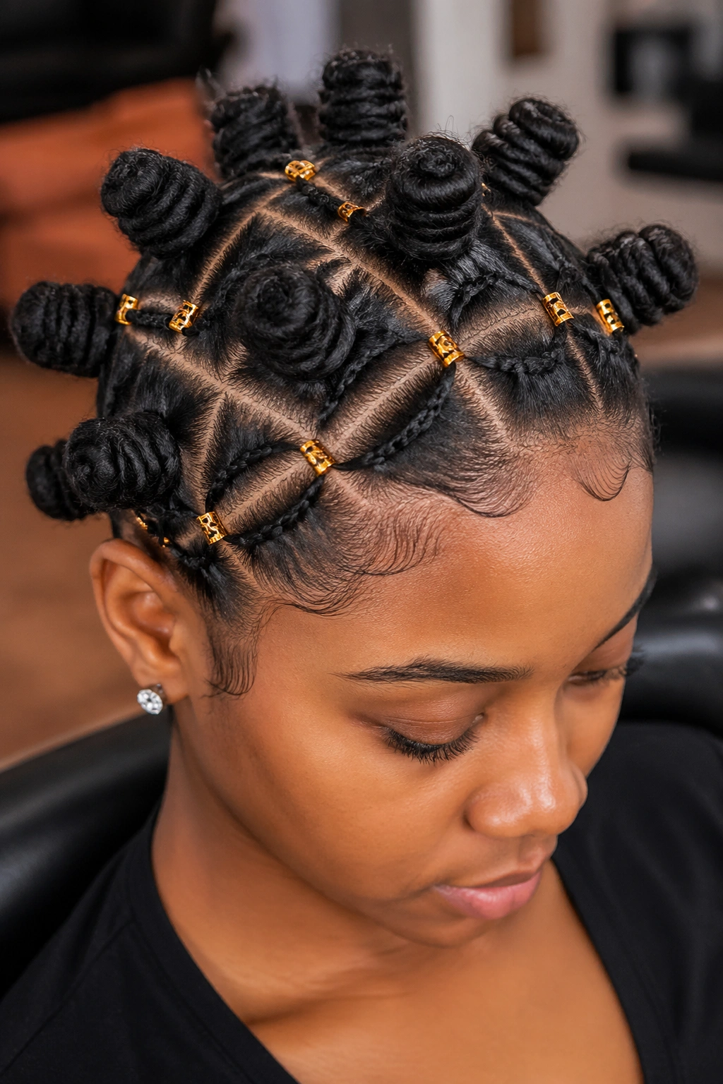 Close-up of a real woman with Bantu Knots and Beaded Parting Sections showing beads along part lines between knots.