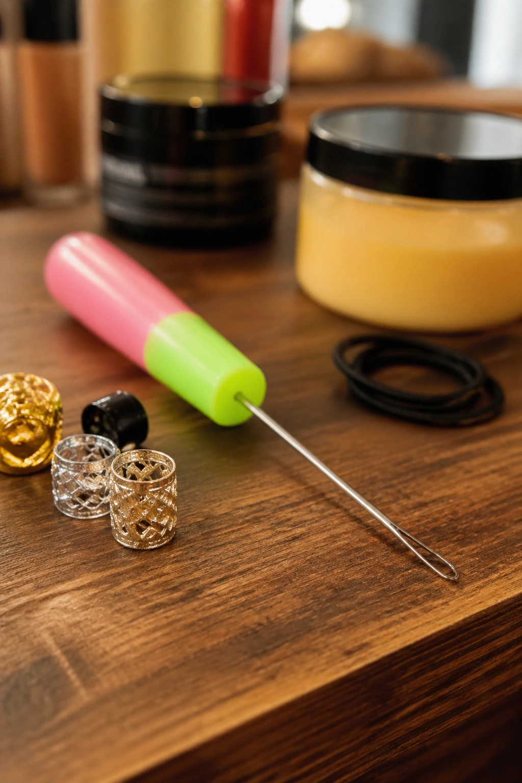 Macro image of bead-threading tool with beads on a wooden counter