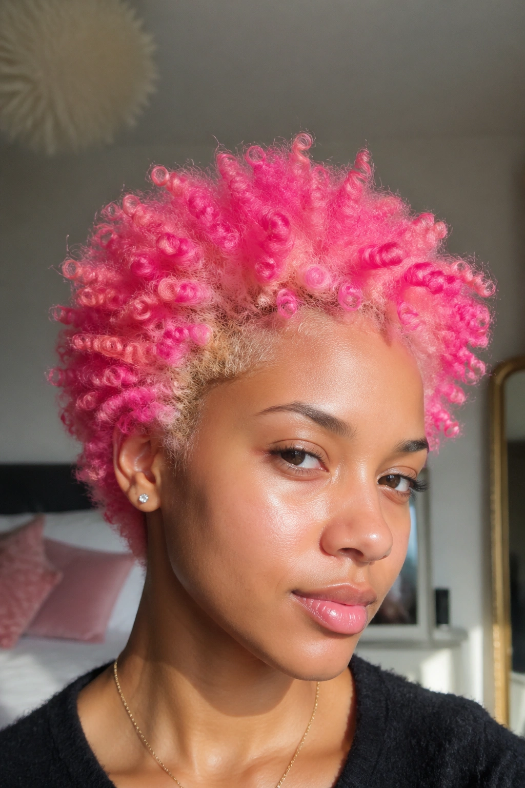 Close-up of a real person with bleached hair and vivid pink curls dominating the frame