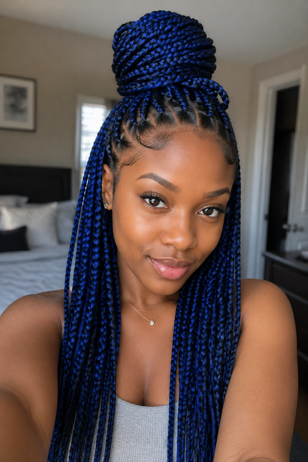 Real person with blue box braids half-up bun
