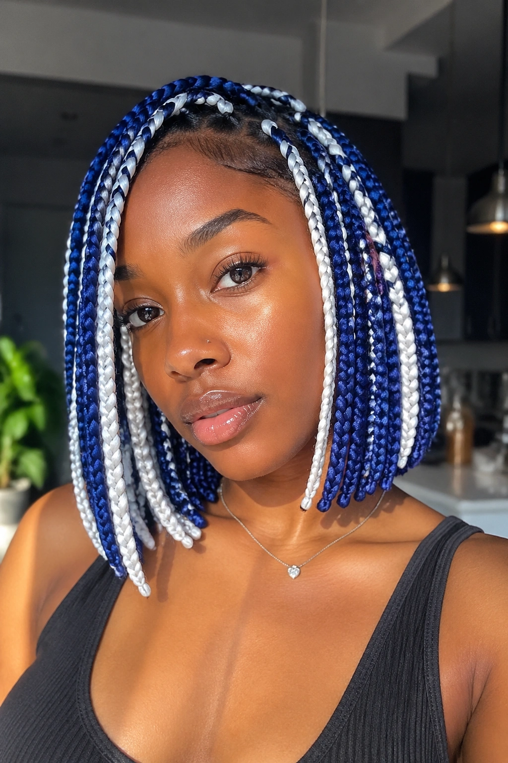 Close-up of a real woman with bob-length blue and white box braids