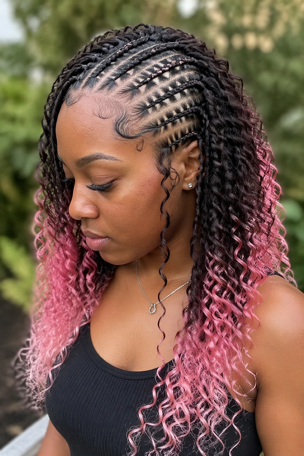 Close-up of a woman with pink-tipped bohemian cornrows.