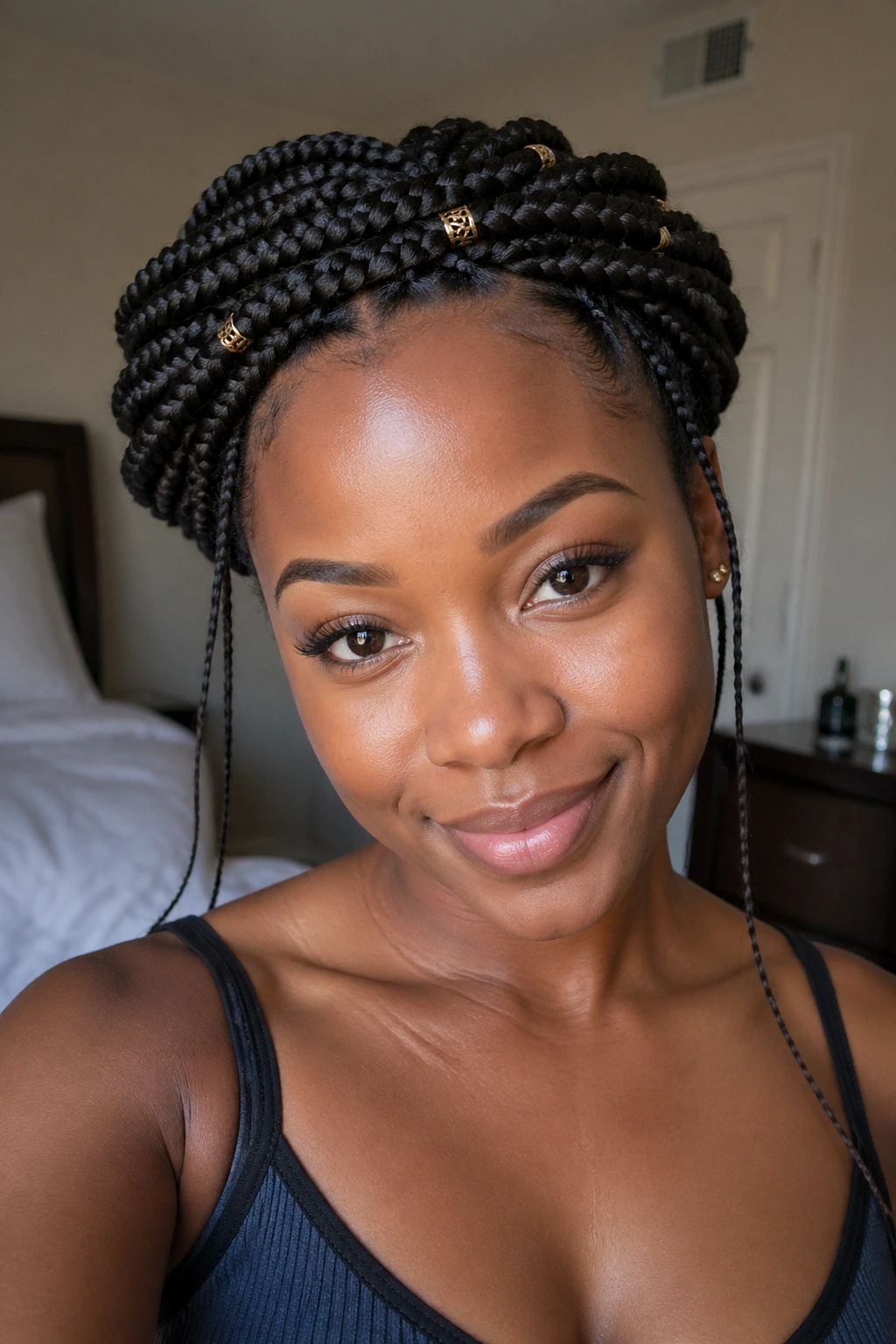 Close-up of a person with a crown made from box braids around the head.