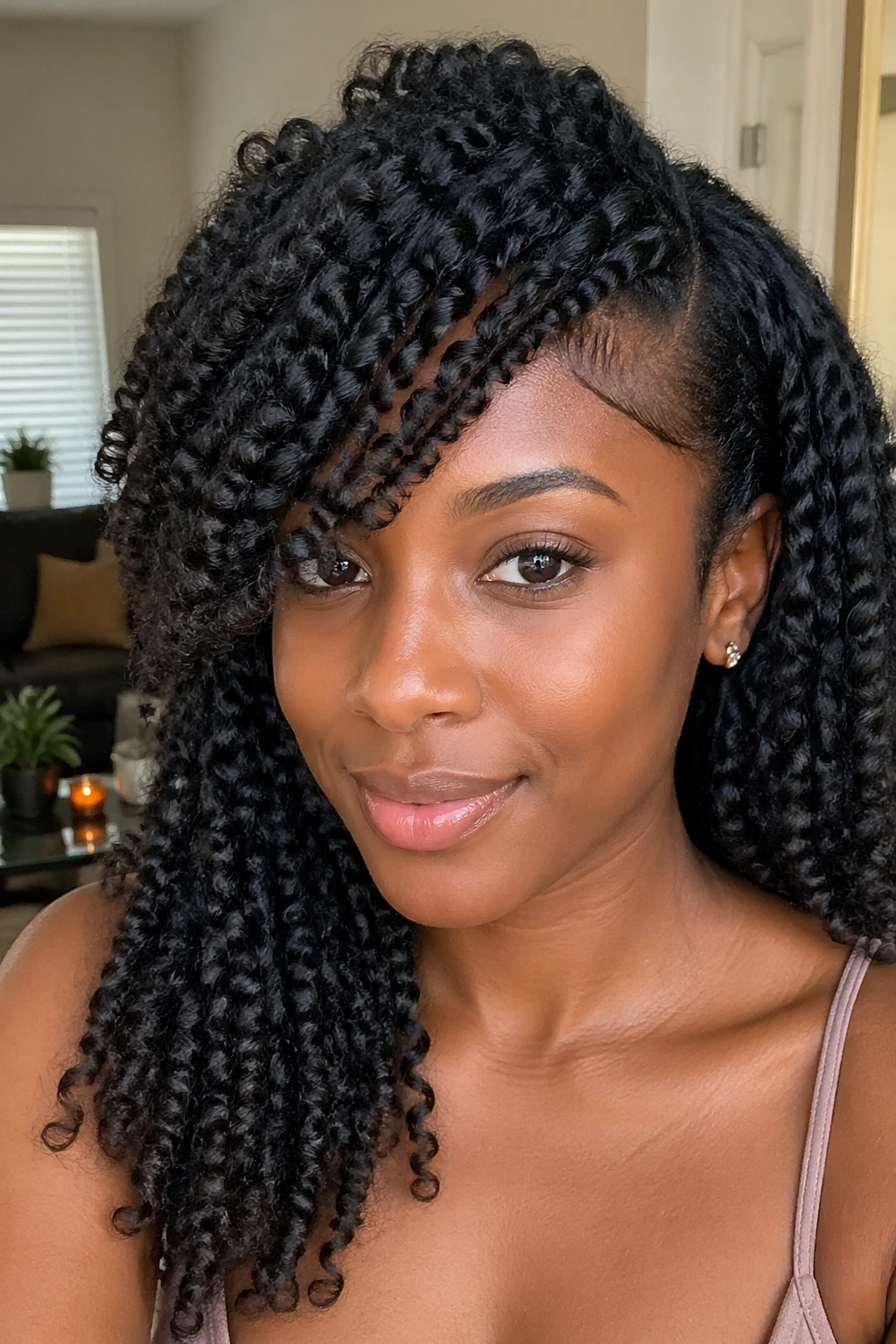 Close-up of a person with a braid-out side bang and defined waves