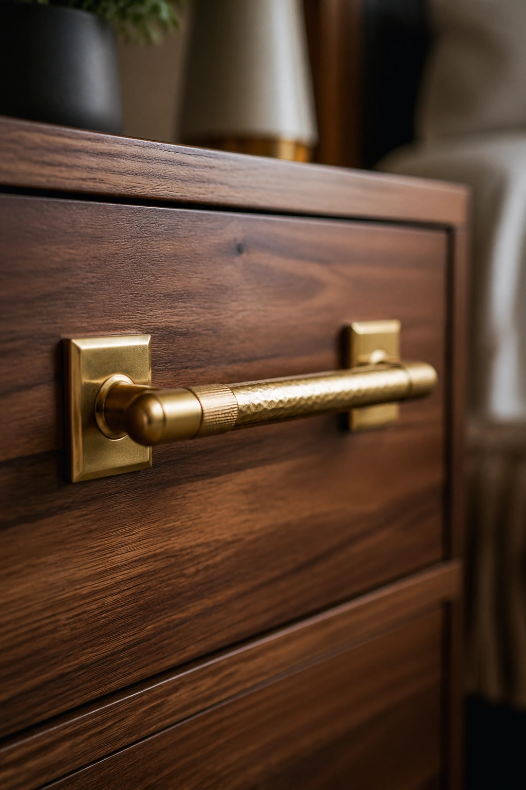 Close-up brass drawer pull on walnut dresser