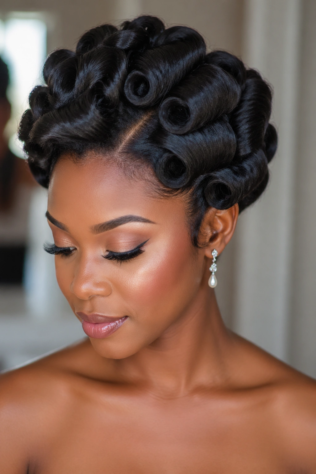 Close-up of a real woman wearing a bridal/formal pin curl hairstyle.