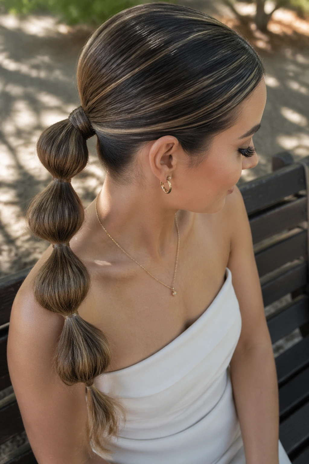 Close-up of a real woman with Bubble Low Ponytail showing evenly spaced bubbles