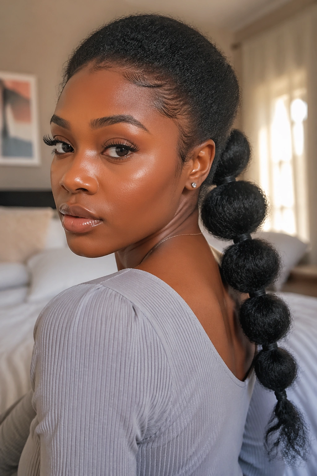 Close-up of a woman with a bubble low ponytail showing segmented bubbles along the ponytail