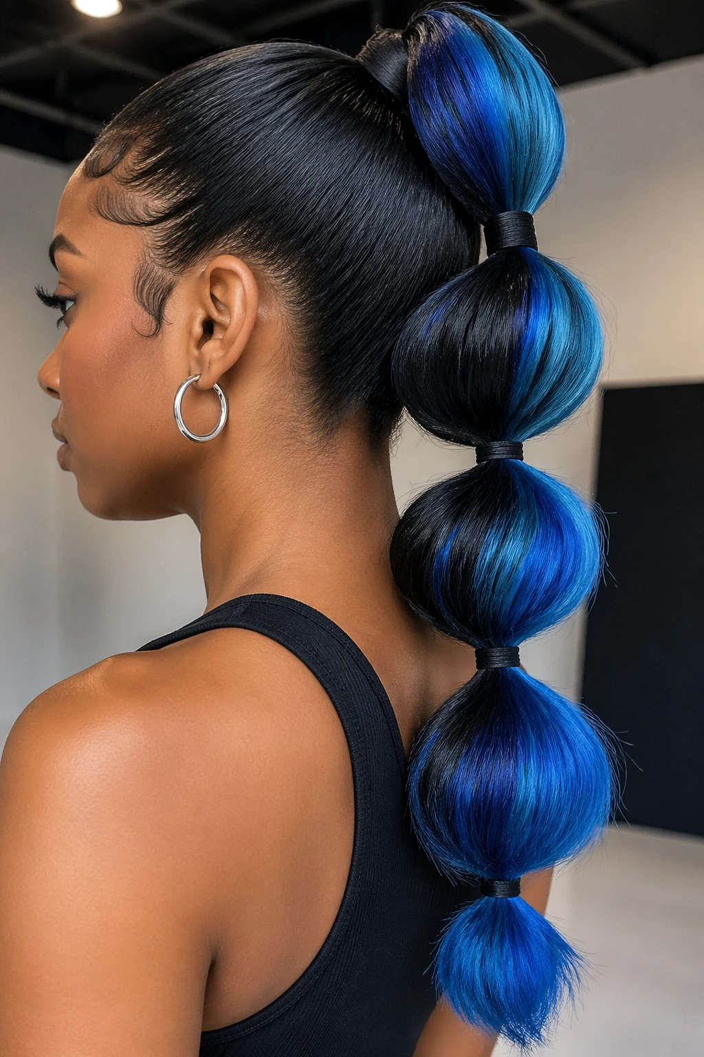 Close-up of a real woman with raven black to cobalt blue bubble ponytail