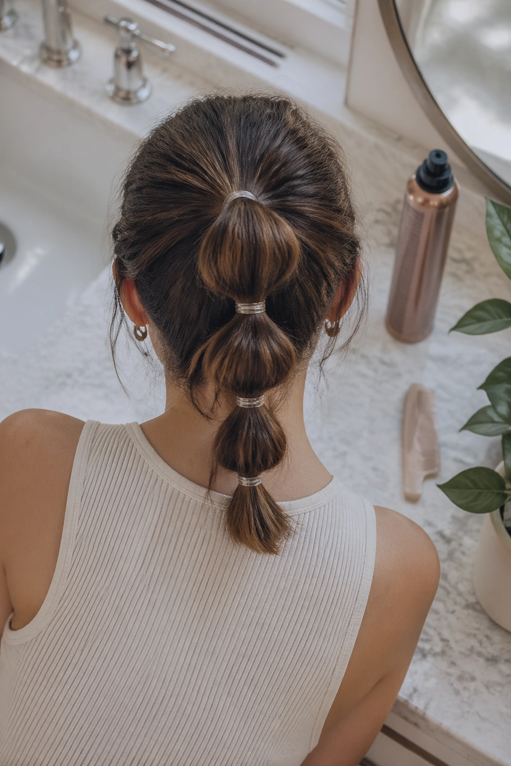 Overhead flat-lay of bubble ponytail styling supplies