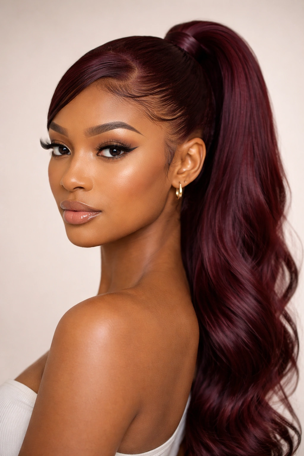 Burgundy ponytail with soft swoop and laid baby hairs
