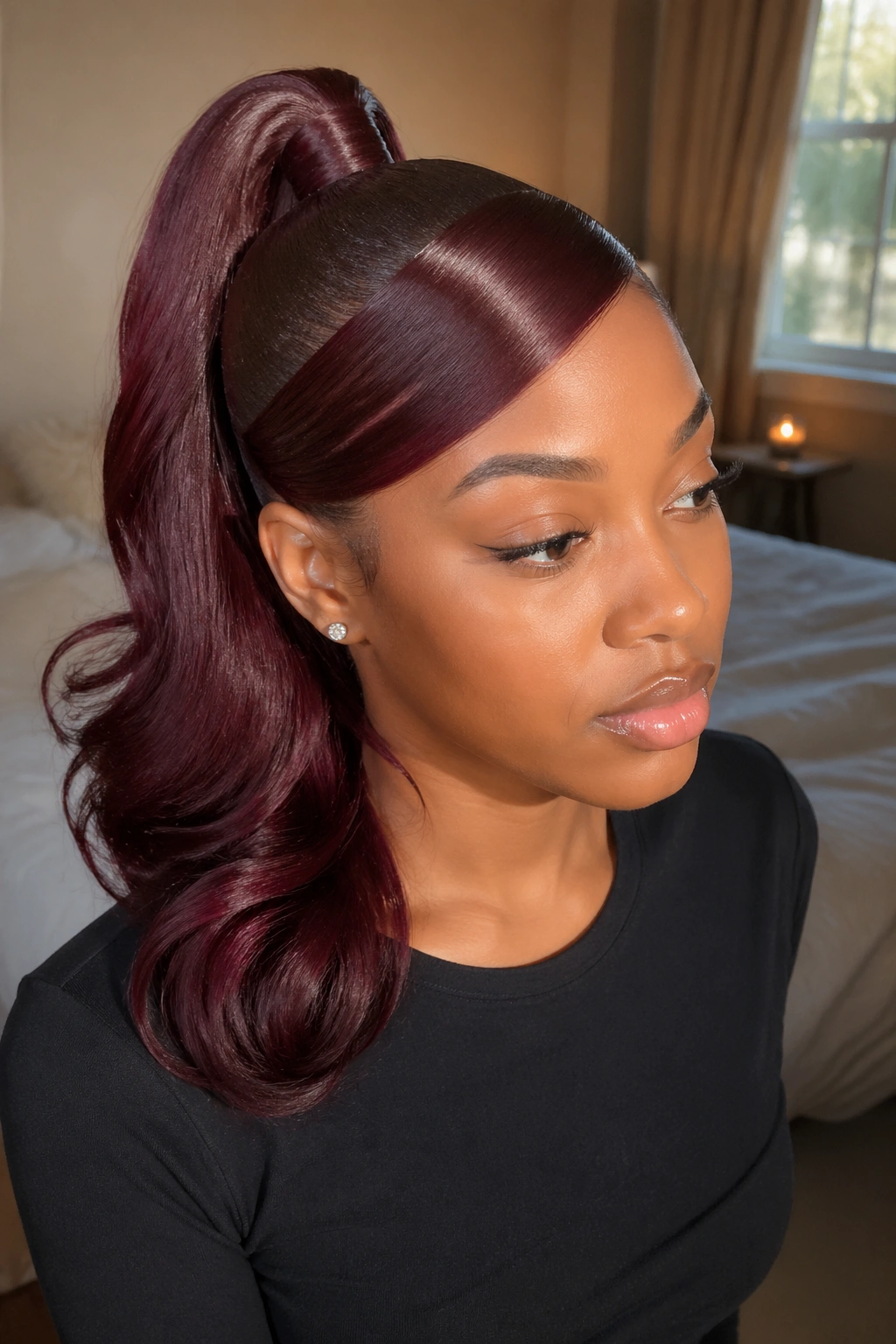 Close-up of a real woman with wrapped-base burgundy swoop ponytail, neat base wrap.