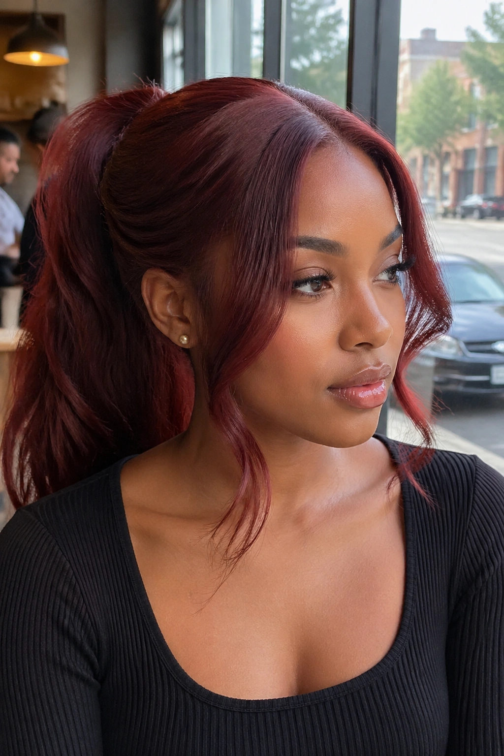 Close-up of a real woman with a cherry-cola ponytail and face-framing pieces