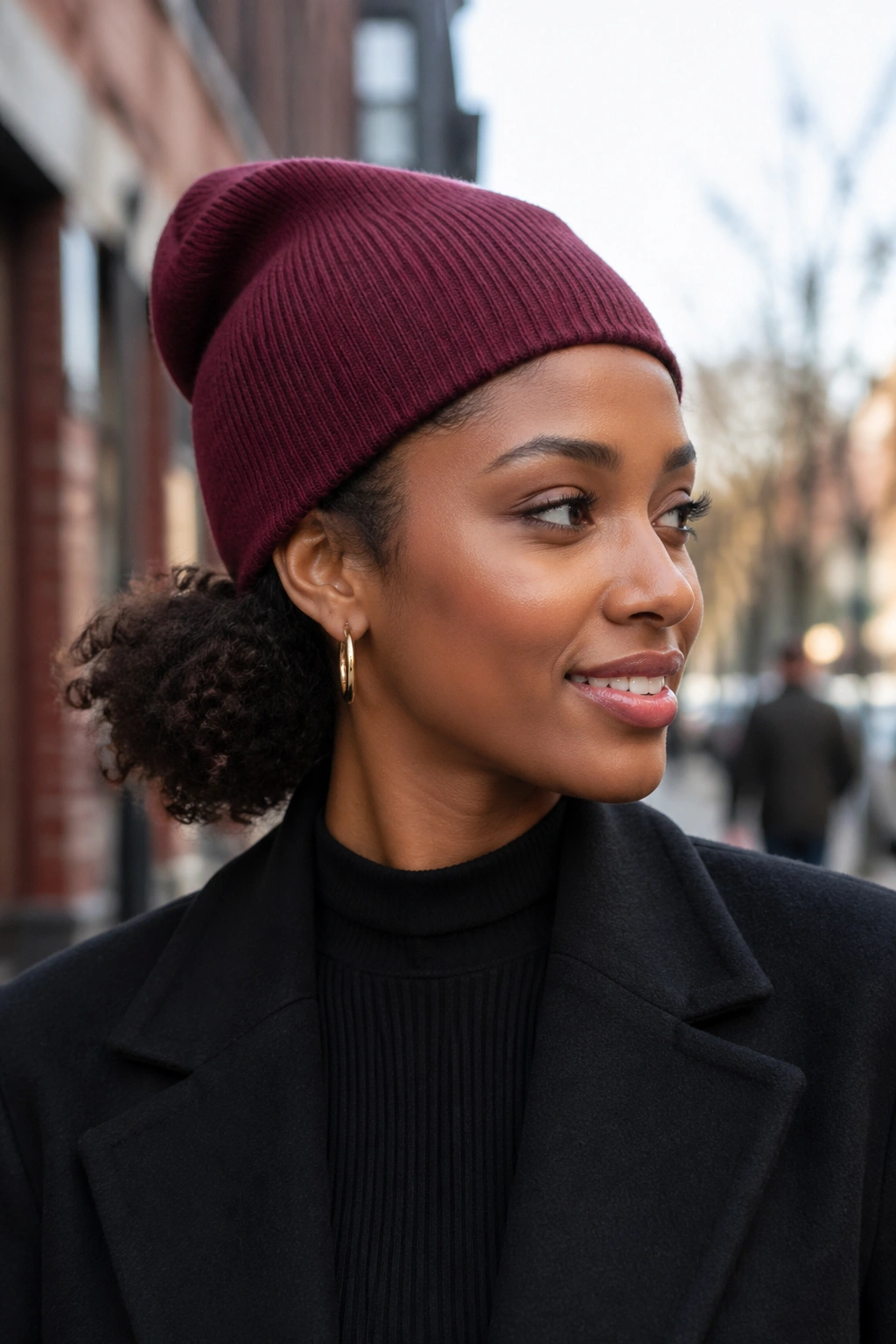 Close-up of a real woman wearing a beanie with a compressed puff under it
