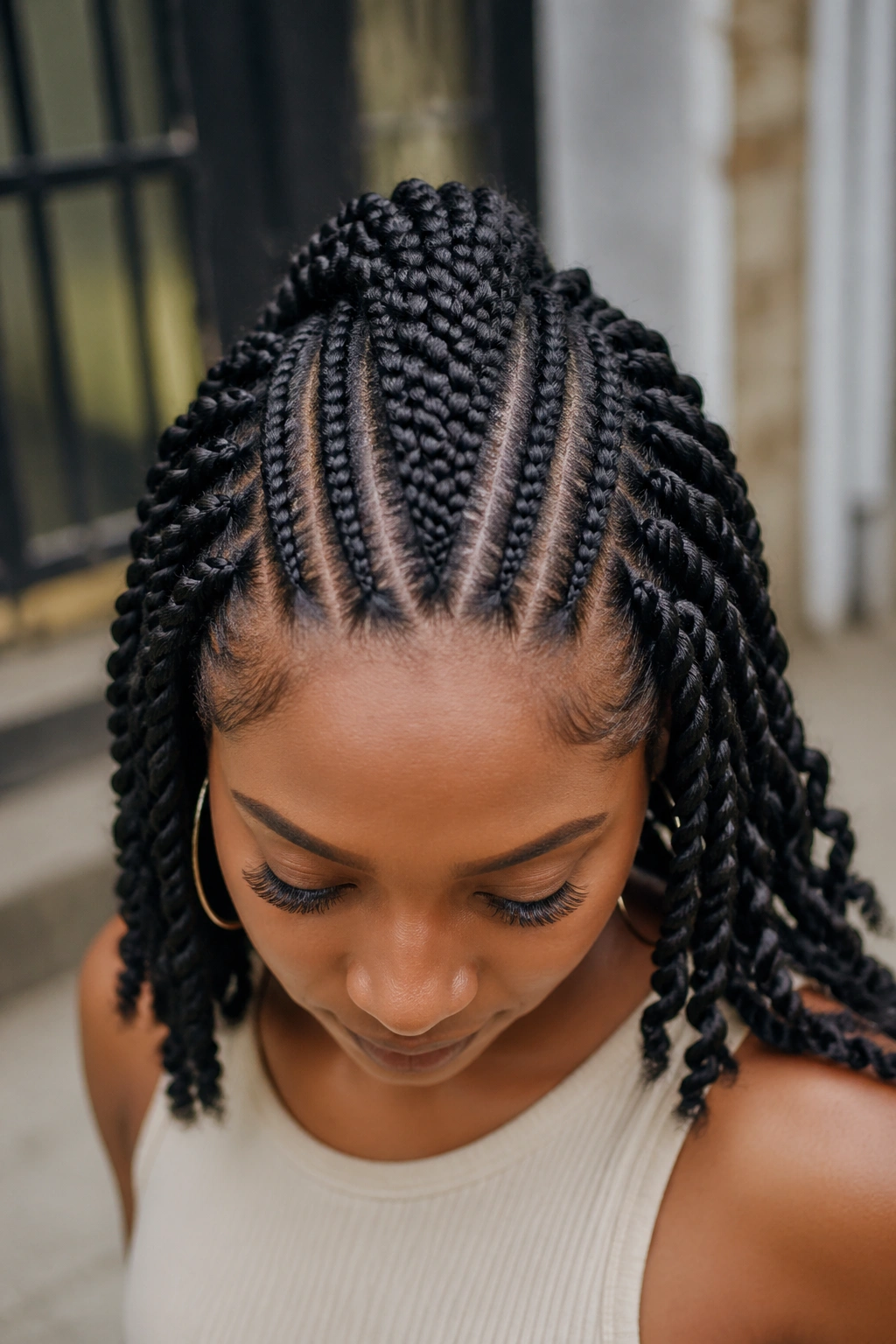Cornrow Mohawk with side twists on a real person, prominent center strip with side twists.