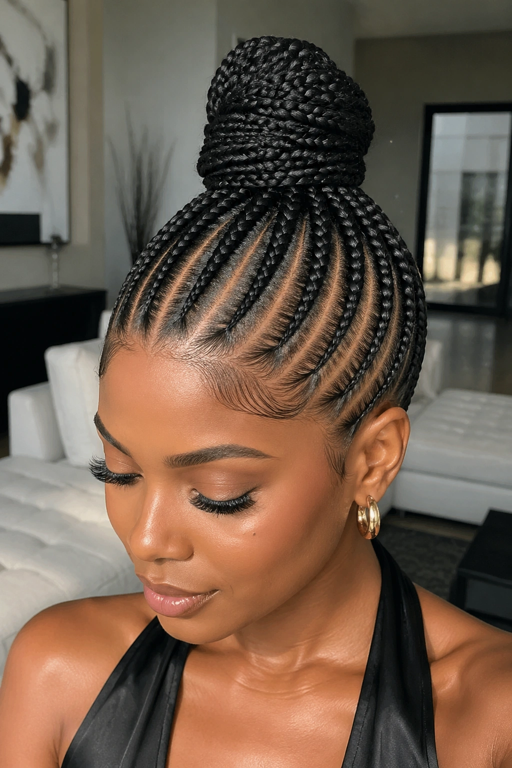 Needle cornrow updo with crown bun on real person.