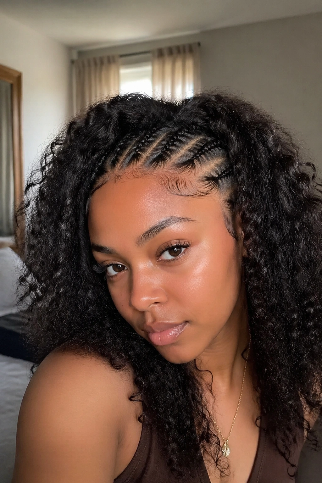 Close-up of a real woman's front hairline with cornrows and loose hair