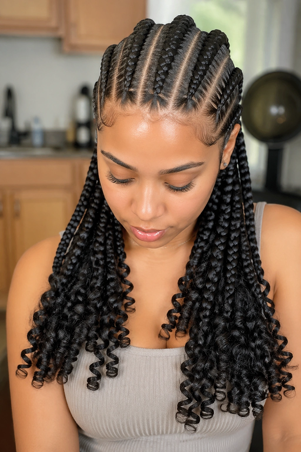Close-up of a real person with big cornrows ending in curly bulk tips