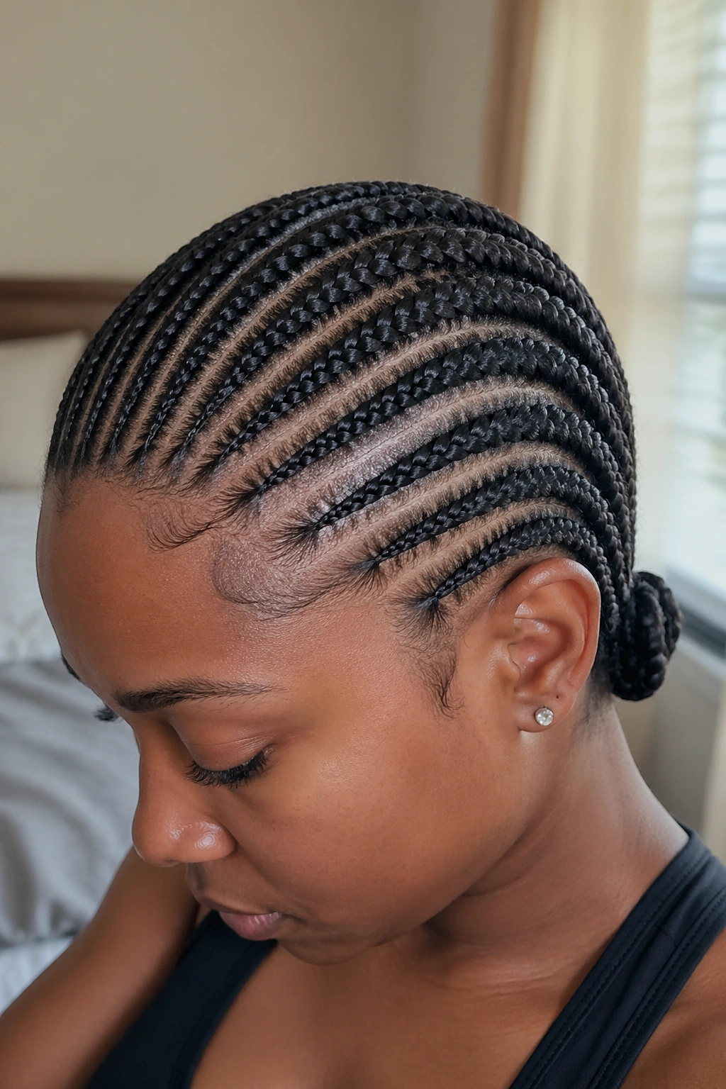 Close-up of a real Black woman's straight-back cornrows from hairline to nape