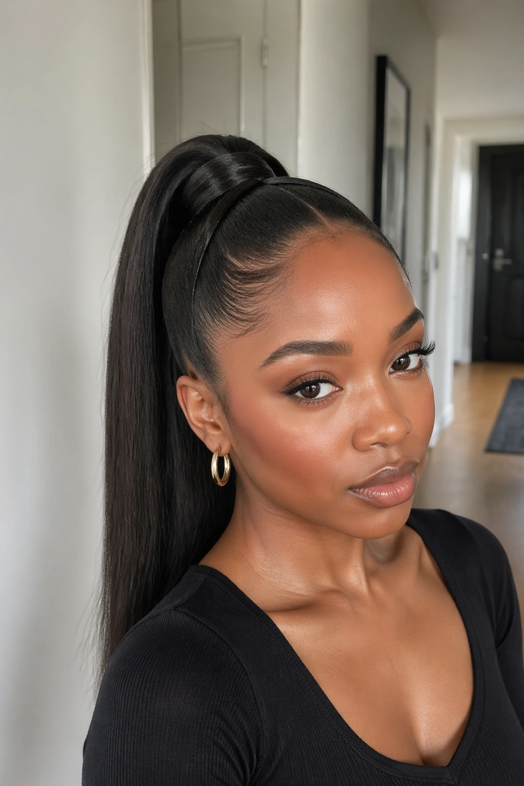 Close-up of a real woman showing crisscrossed sections over the ponytail base in soft daylight