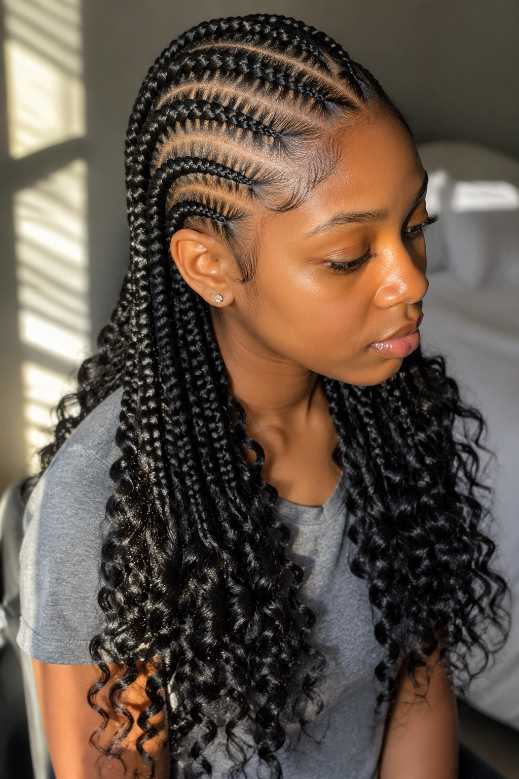 Close-up of a real person with feed-in braids ending in crochet curls