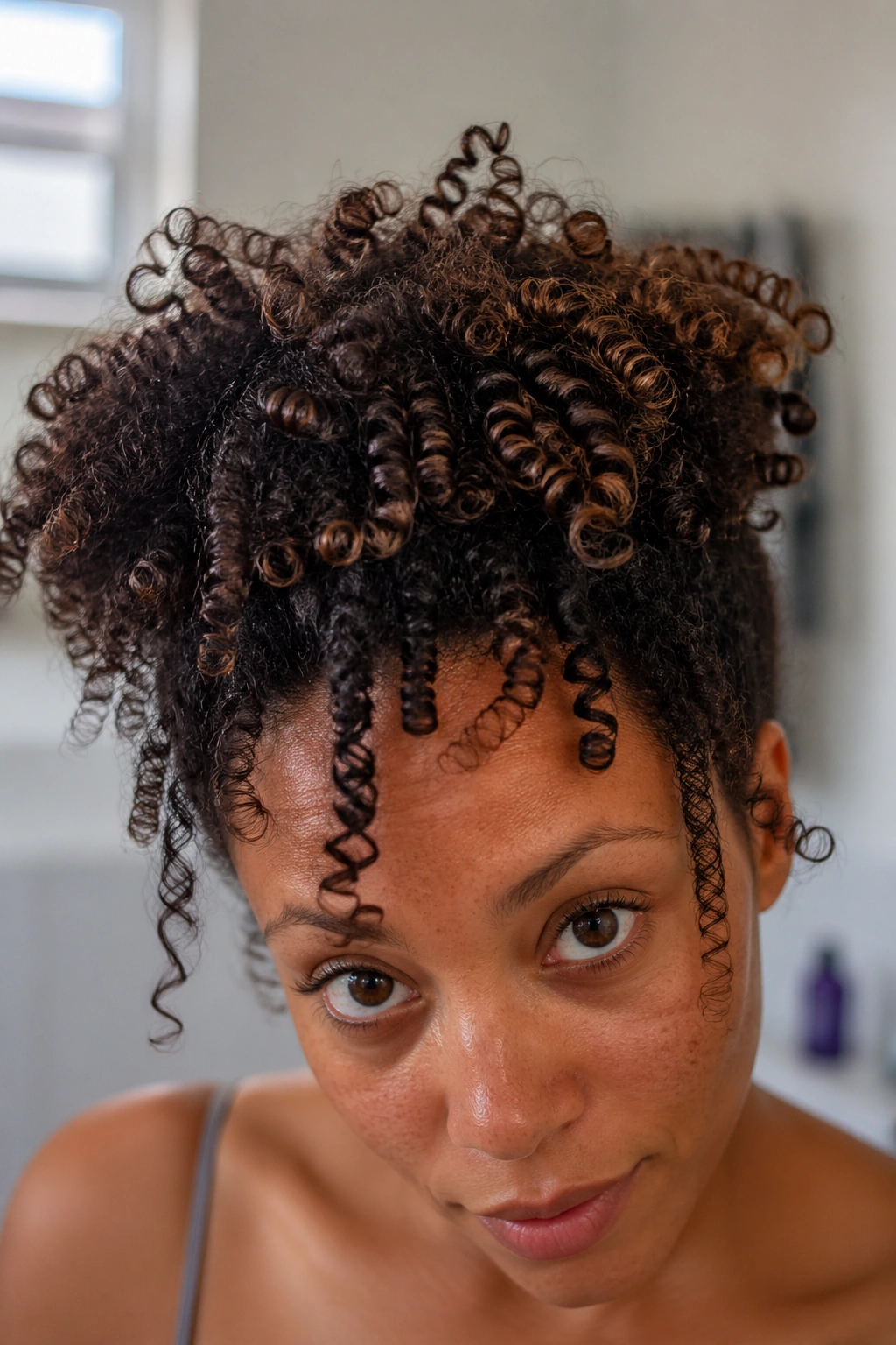 Close-up of a real person's hair showing mixed curl patterns (3A-4C) for curl pattern understanding