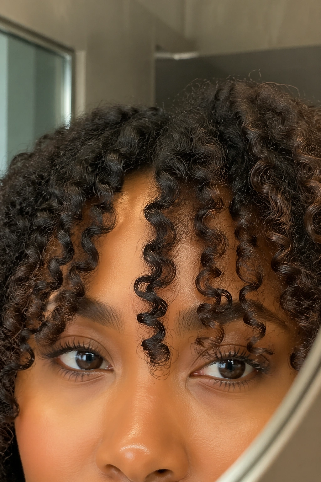 Soft curly curtain bangs close-up on Black hair