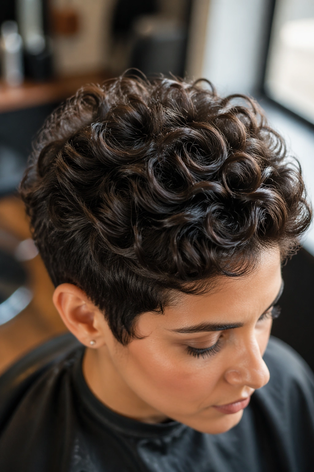 Close-up of crown-layer curls in a curly pixie cut.