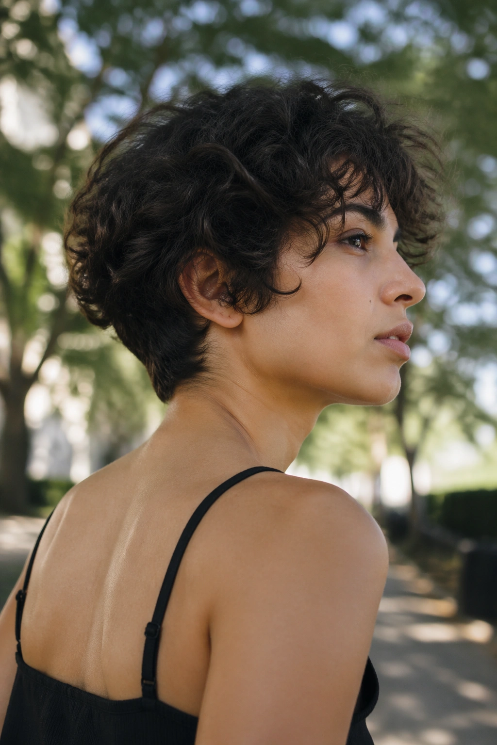 Shaggy tapered cut on thick curls outdoors