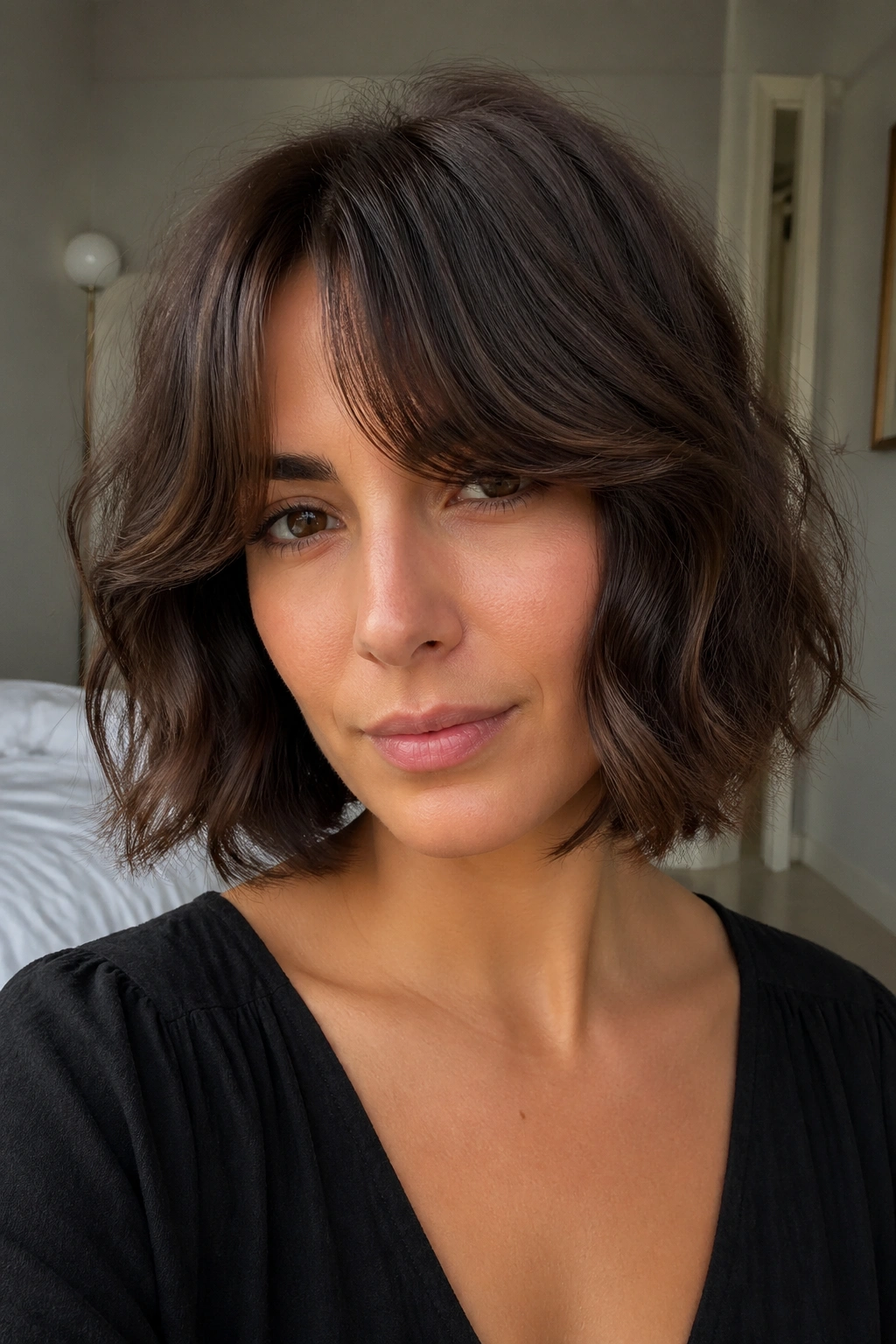 Real woman with curtain bangs and thick wavy bob