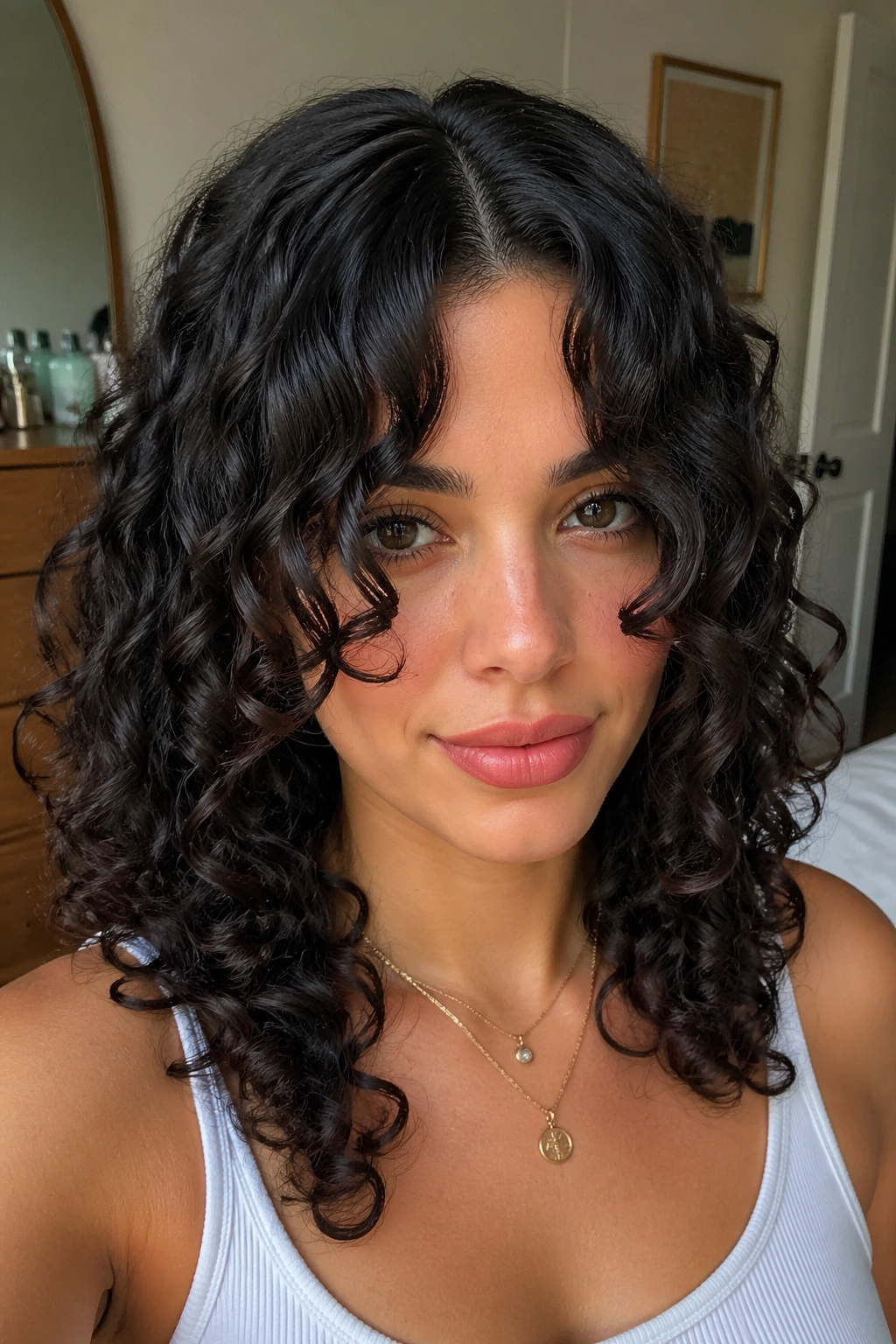 Close-up of a real person with deep center-part curtain bangs curling to the cheeks