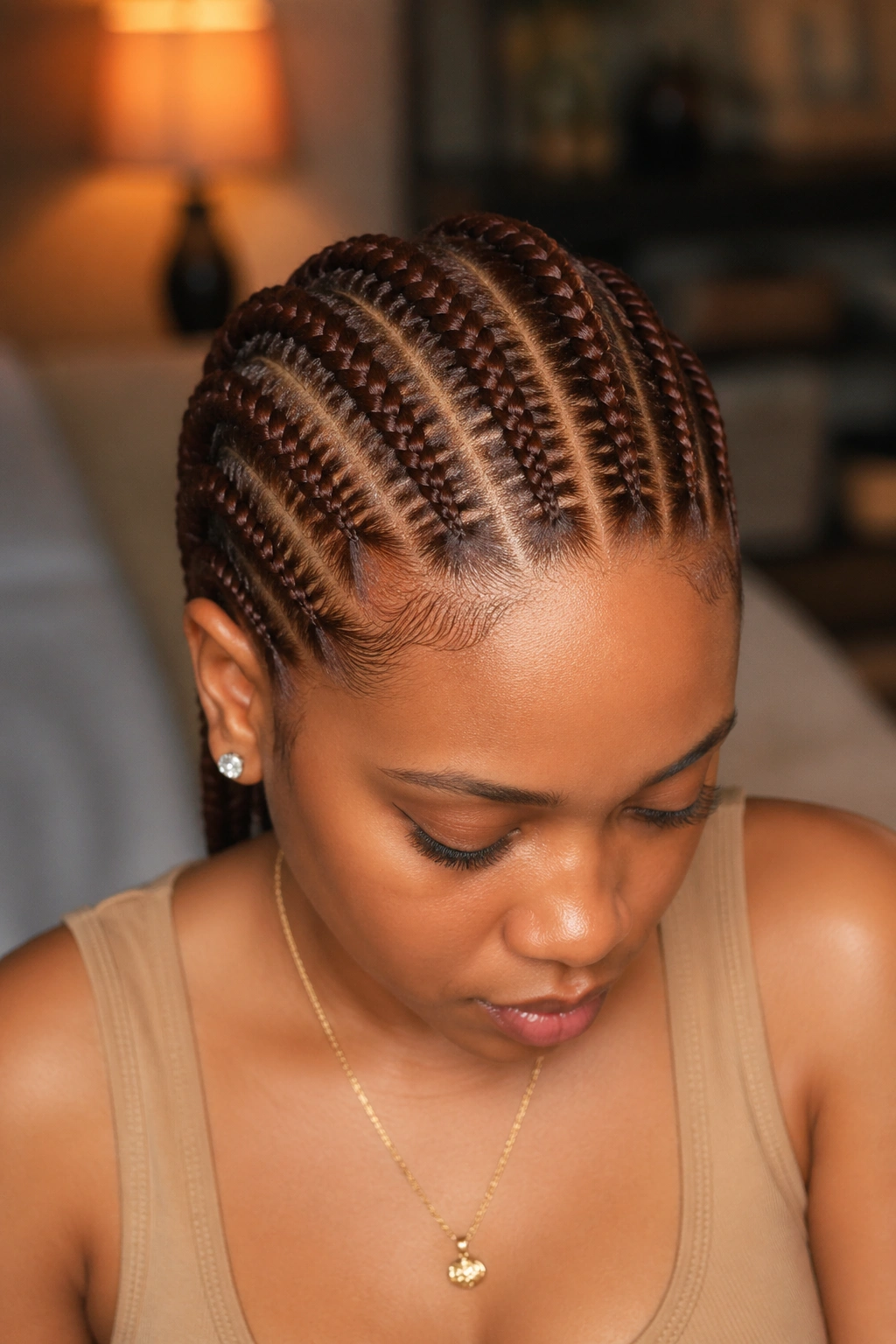 Portrait of a real person with straight-back cornrows in deep auburn