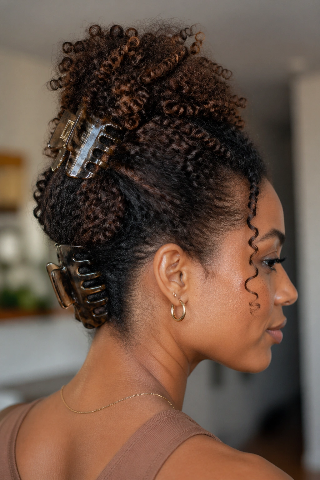 Two claw clips holding a two-section updo on a real person