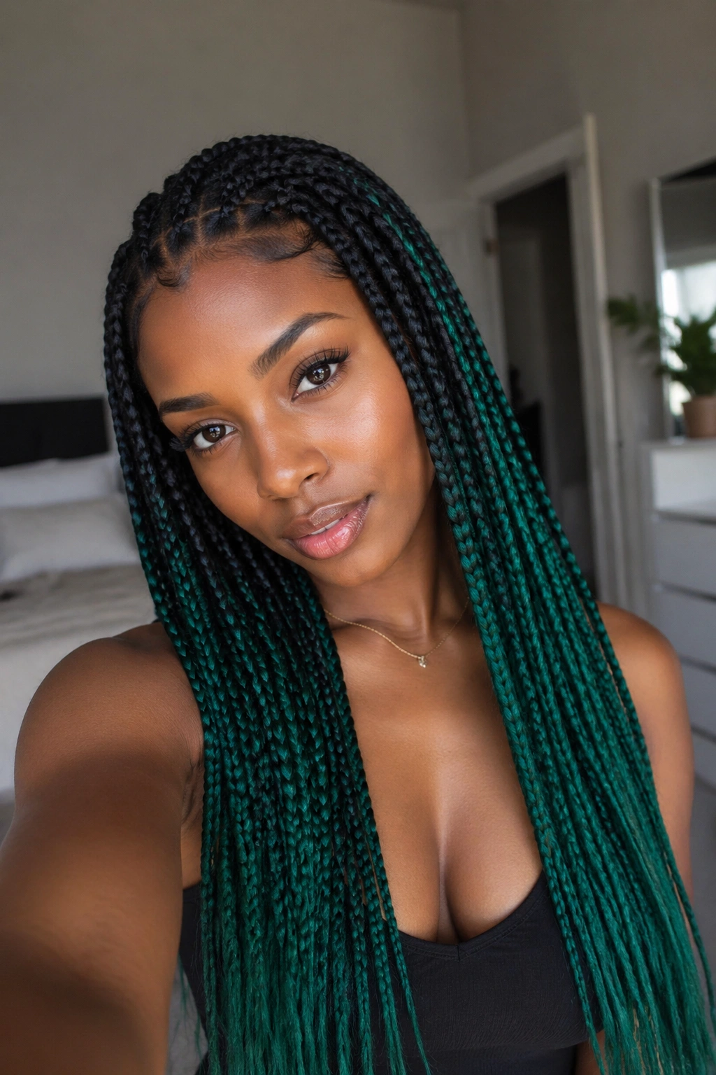 Close-up portrait of a real person with black-to-emerald ombré box braids
