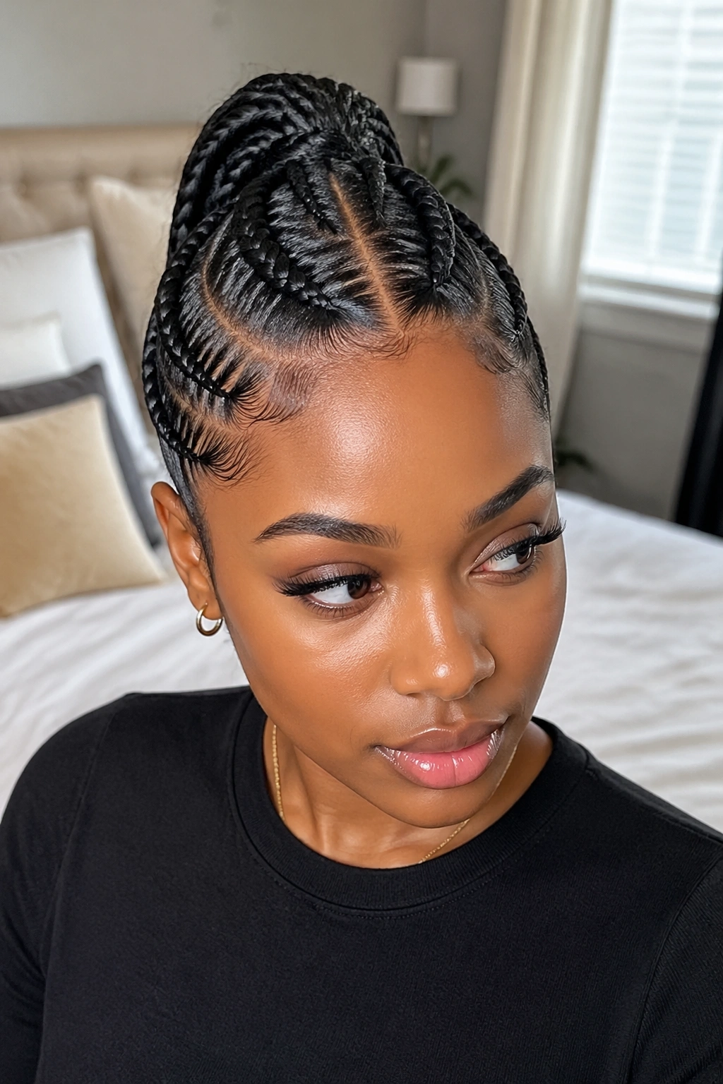 Close-up of two feed-in braids forming a single ponytail on a real woman with short hair