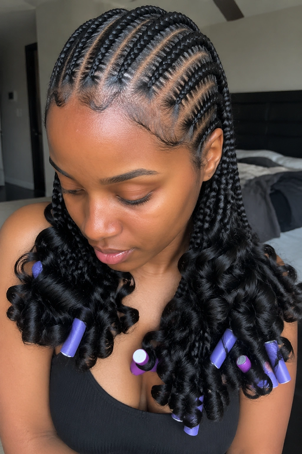Real person with six feed-in cornrows ending in flexi rod curls