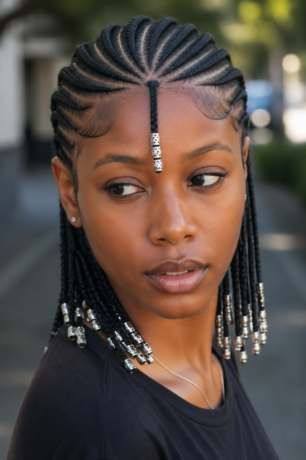 Fulani-inspired cornrows with silver accent beads on a real person