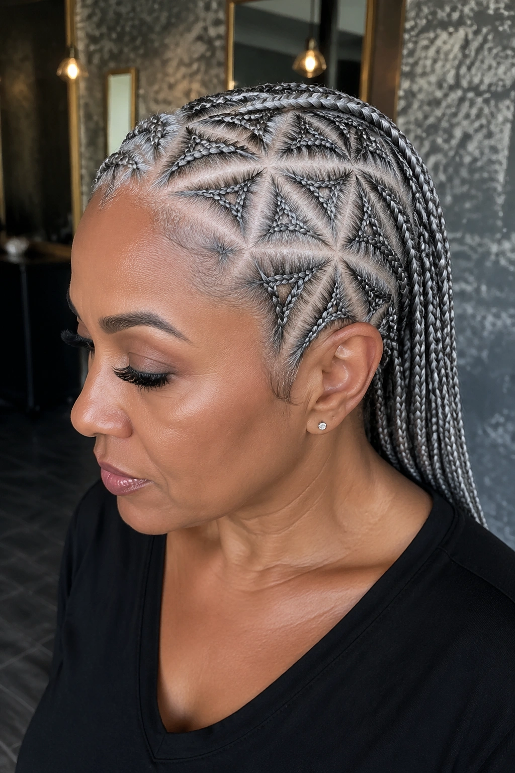Close-up of platinum gray geometric cornrows with bold parts on a real person.