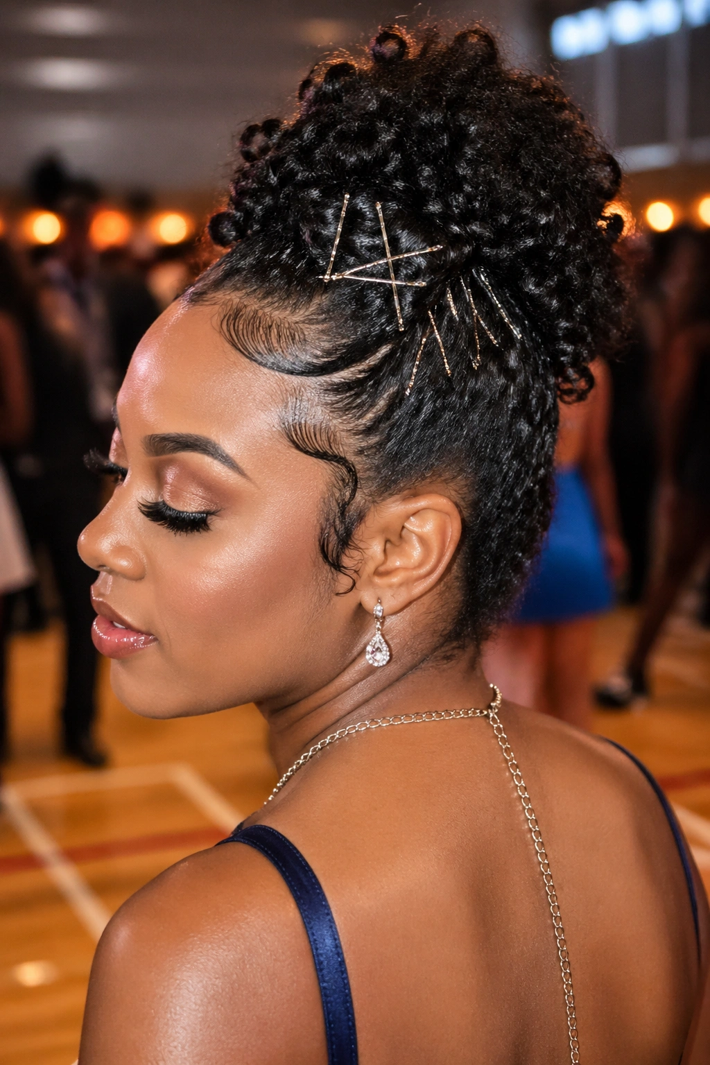 Close-up of a woman with pinned hairstyle under warm dance lighting