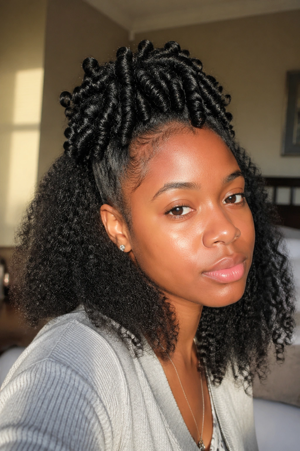 Close-up of a real woman with half-up straw curls, crown curls defined.