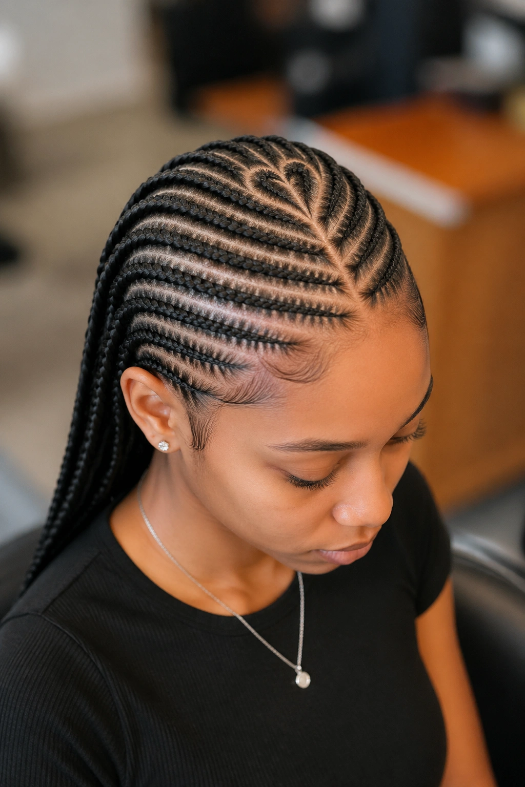 Close-up of heart-shaped crown part in cornrows on a real person