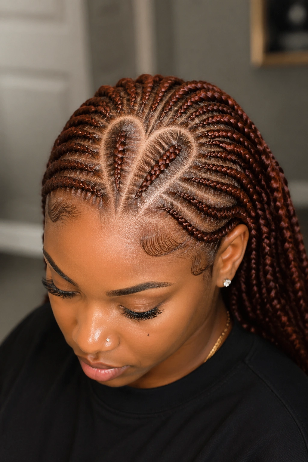 Heart-shaped auburn cornrow partings on a real person