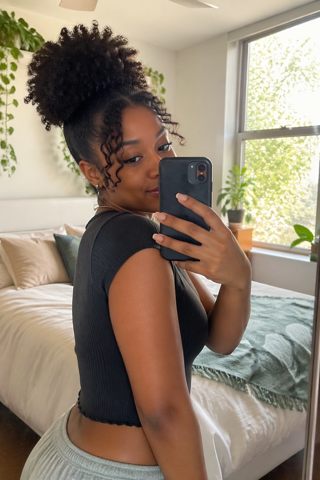 High puff with curly bang tendrils framing face