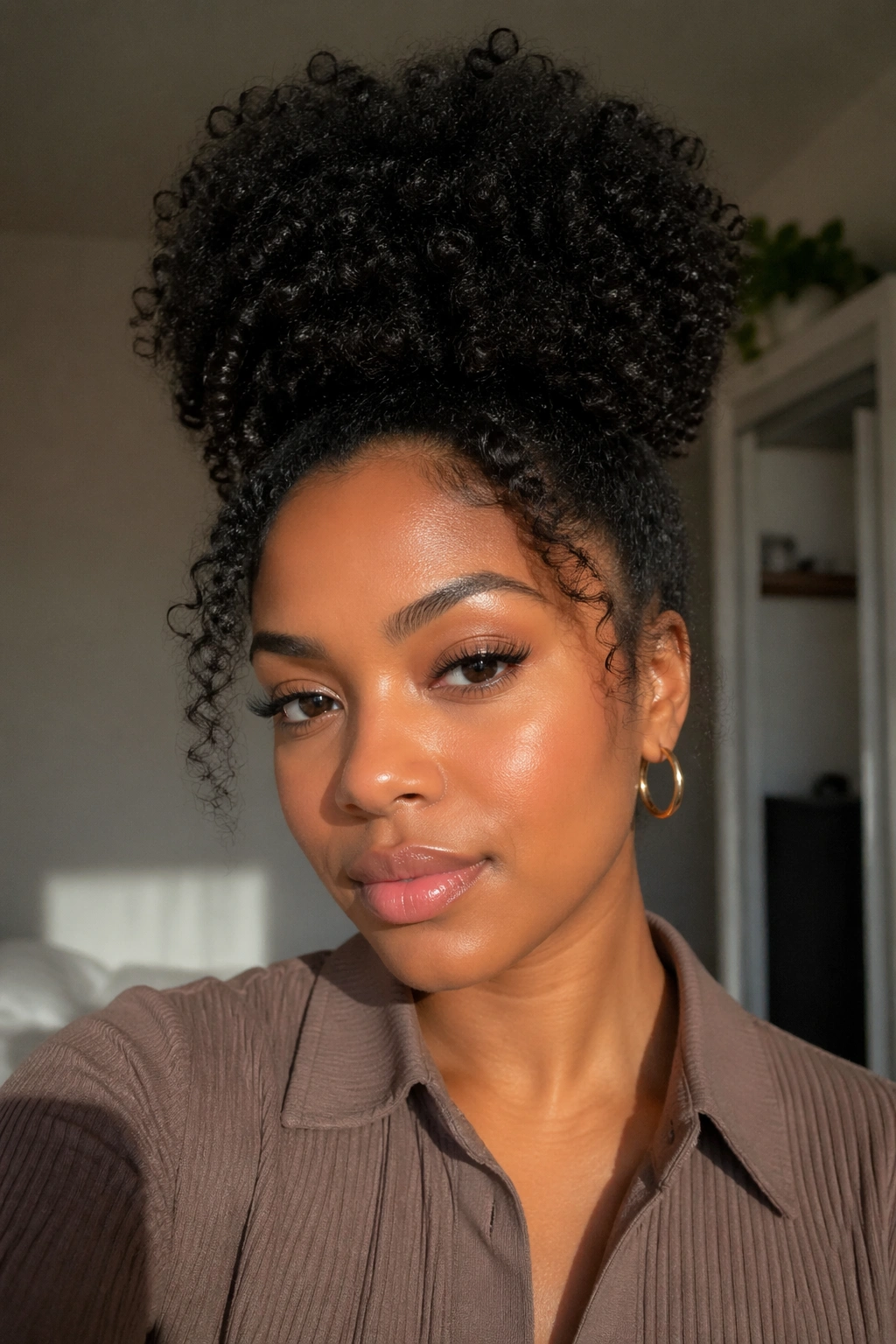 Close portrait of a real woman with a high puff hairstyle in soft indoor light