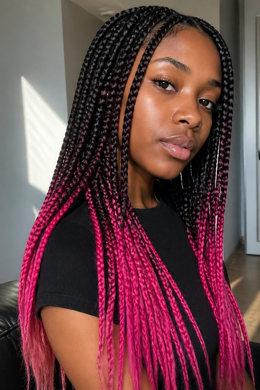 Close-up of a real woman with hot pink dip-dye ends on box braids.