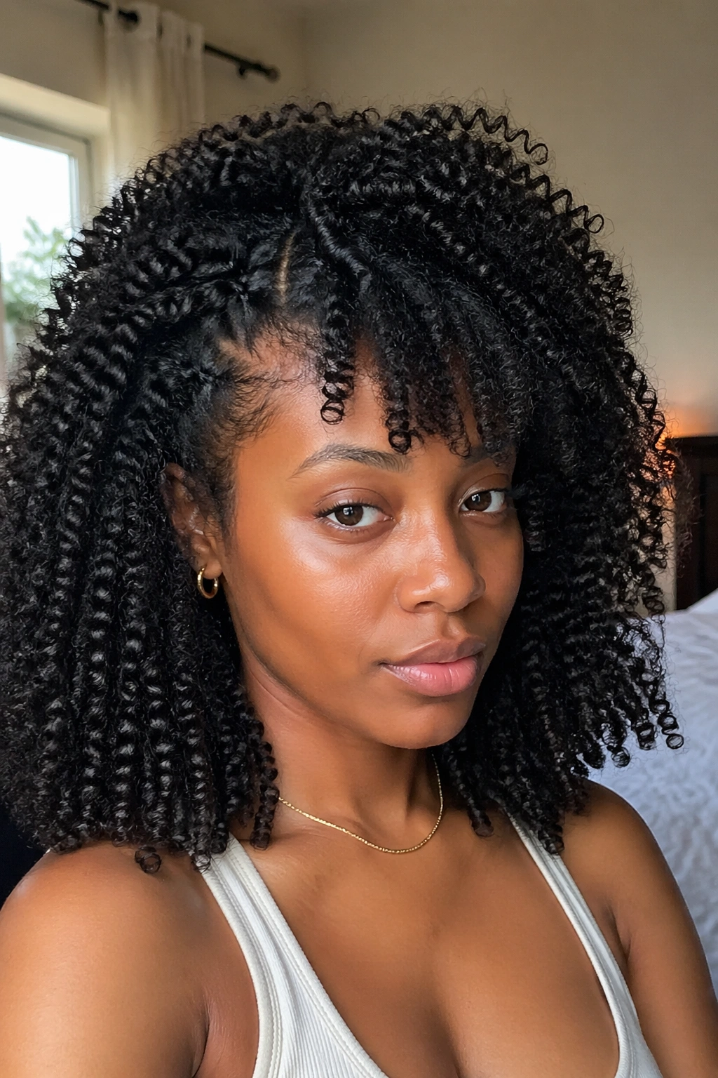 Real woman with kinky curly sew-in blending with type 4 leave-out showing texture