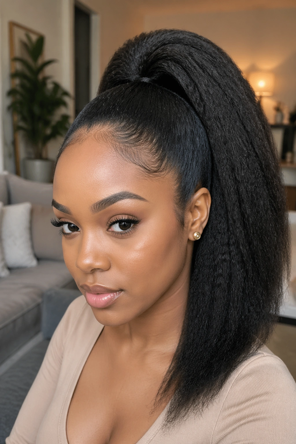 Close-up of a real woman with kinky straight quick weave ponytail in a cozy room