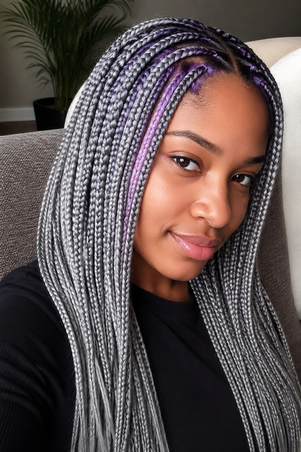 Real person with knotless grey braids and purple feed-in streaks.