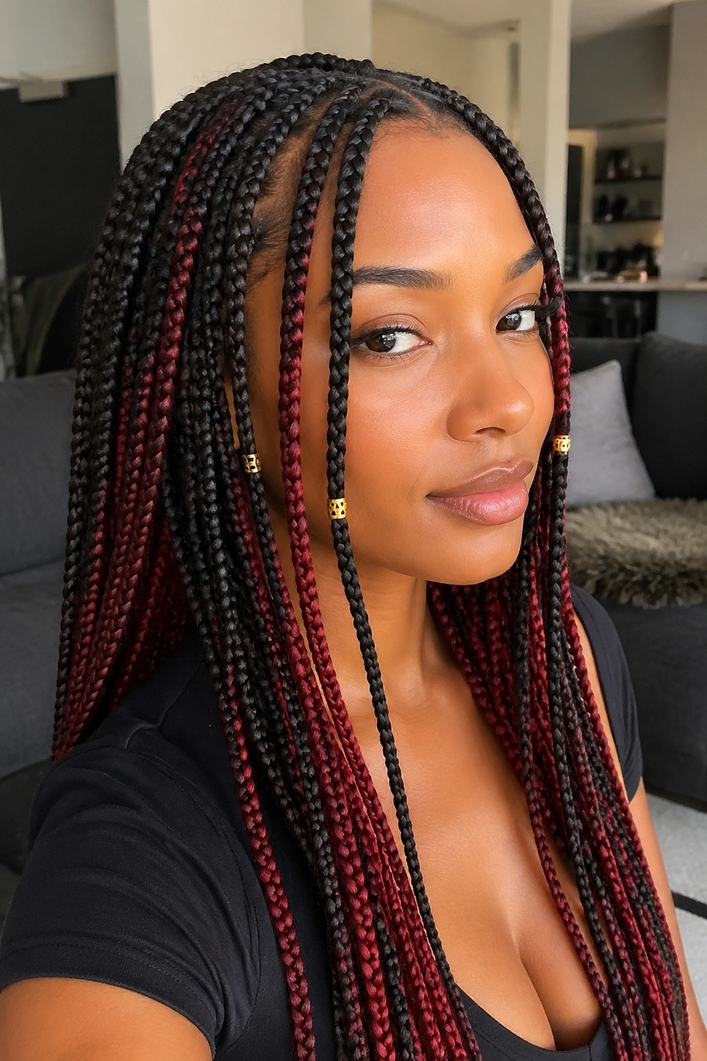 Real person with knotless red peekaboo braids and crimson streaks